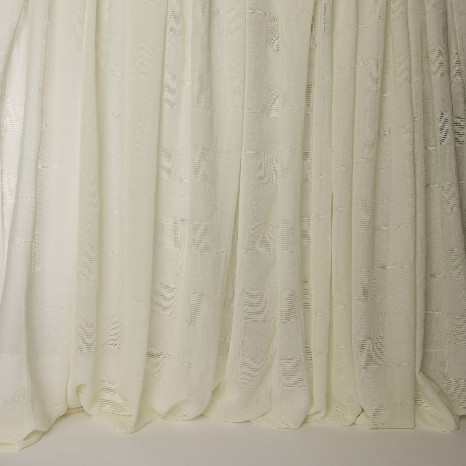 Cream wool drapery swatch with subtle woven texture and soft vertical folds