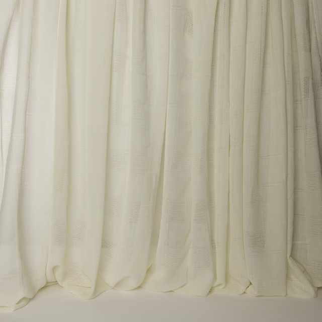 Cream wool drapery swatch with subtle woven texture and soft vertical folds