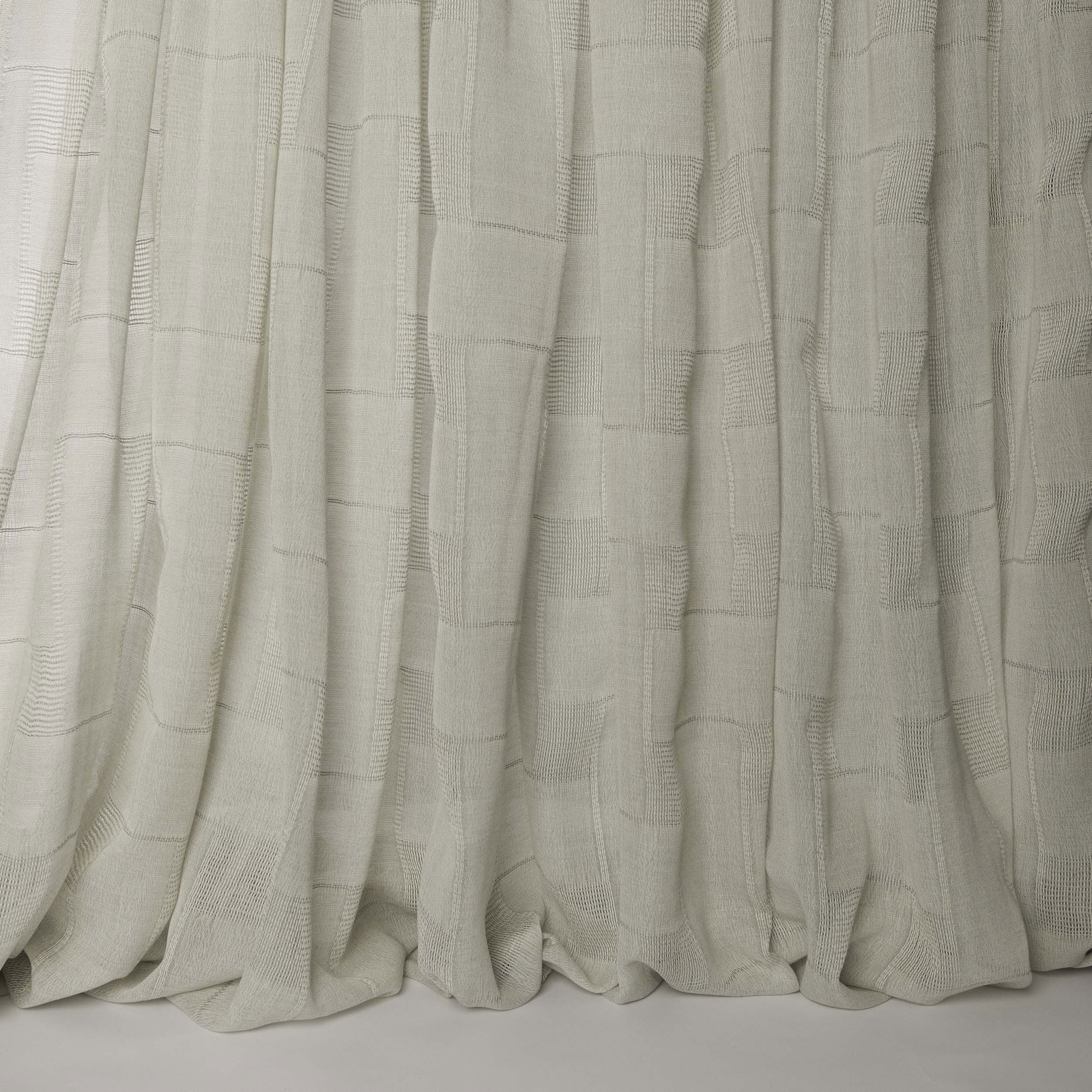 Soft ivory cream wool fabric with subtle woven grid texture and draped folds
