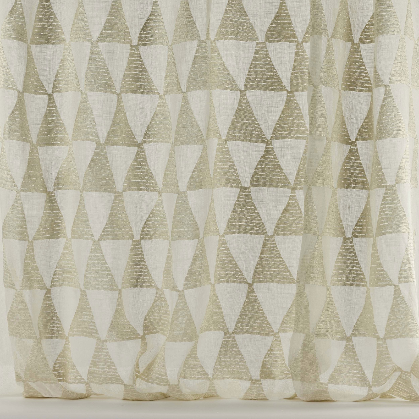Ivory geometric fabric with oat triangles on a pale woven ground