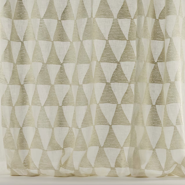 Ivory geometric fabric with oat triangles on a pale woven ground