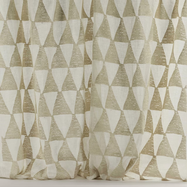 Warm shell-beige geometric triangle fabric with a soft woven texture