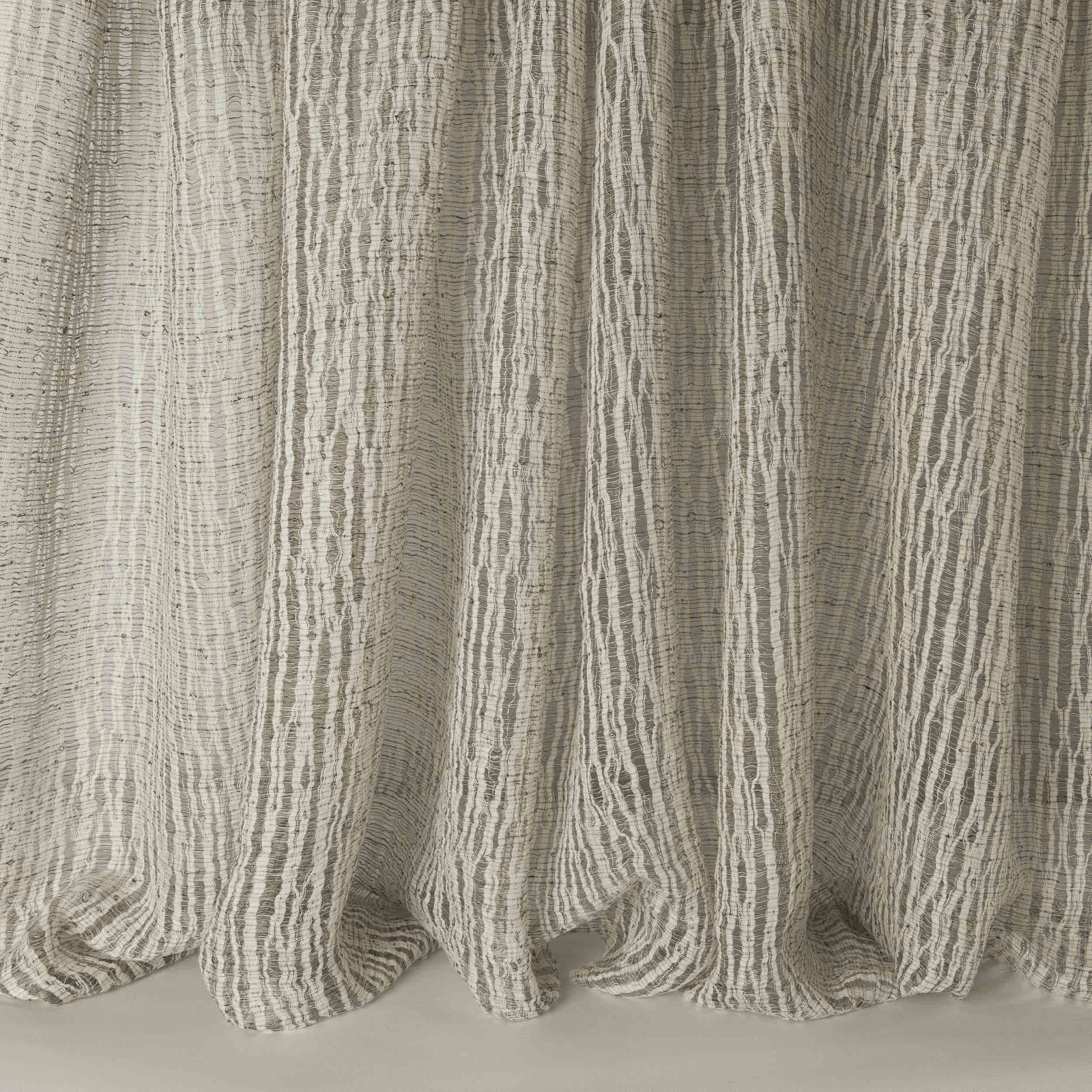 Textured vertical stripe fabric in soft taupe-ebony linen blend folds