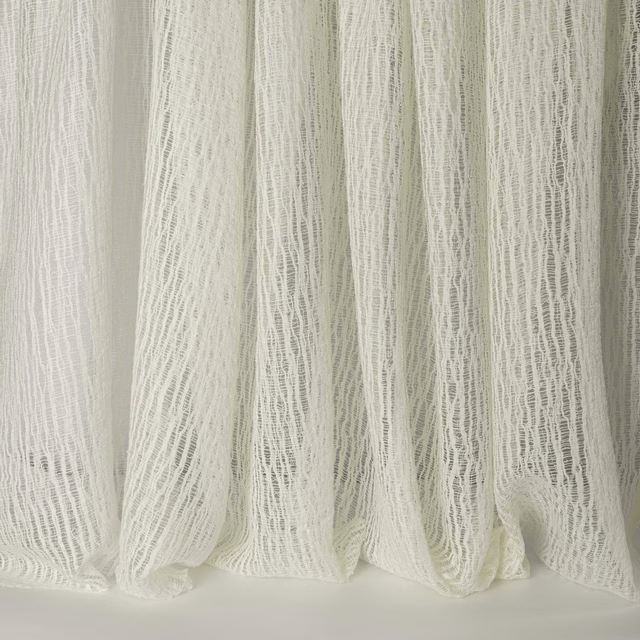 Sheer ivory-white linen-look fabric with a crinkled vertical texture and soft folds