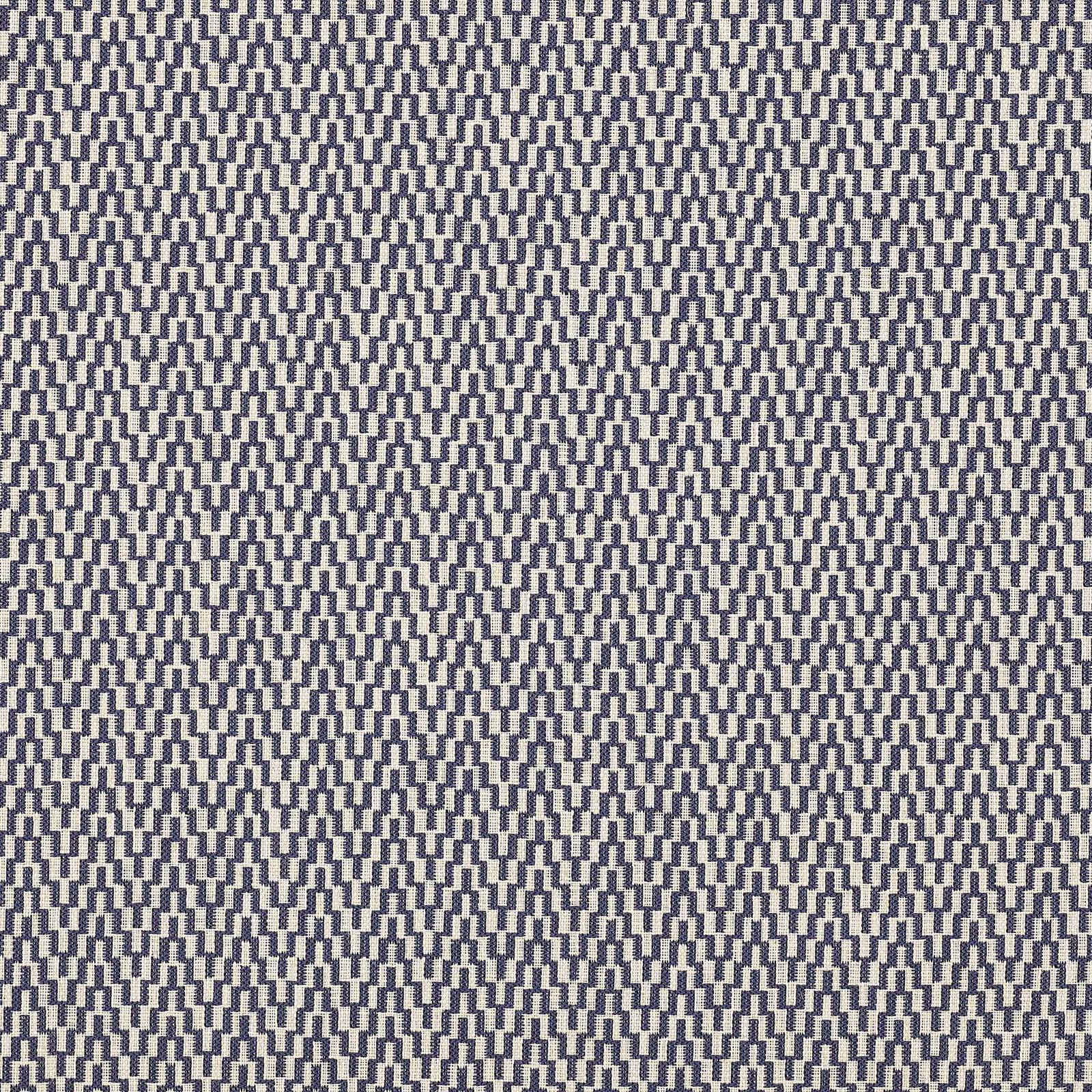 Close-up of a small indigo geometric weave on a pale ground