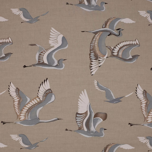 Beige linen-blend fabric with large flying bird motif in blue-grey, white and taupe