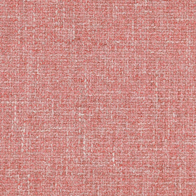Soft rosy coral woven fabric with a nubby textured surface and creamy flecks