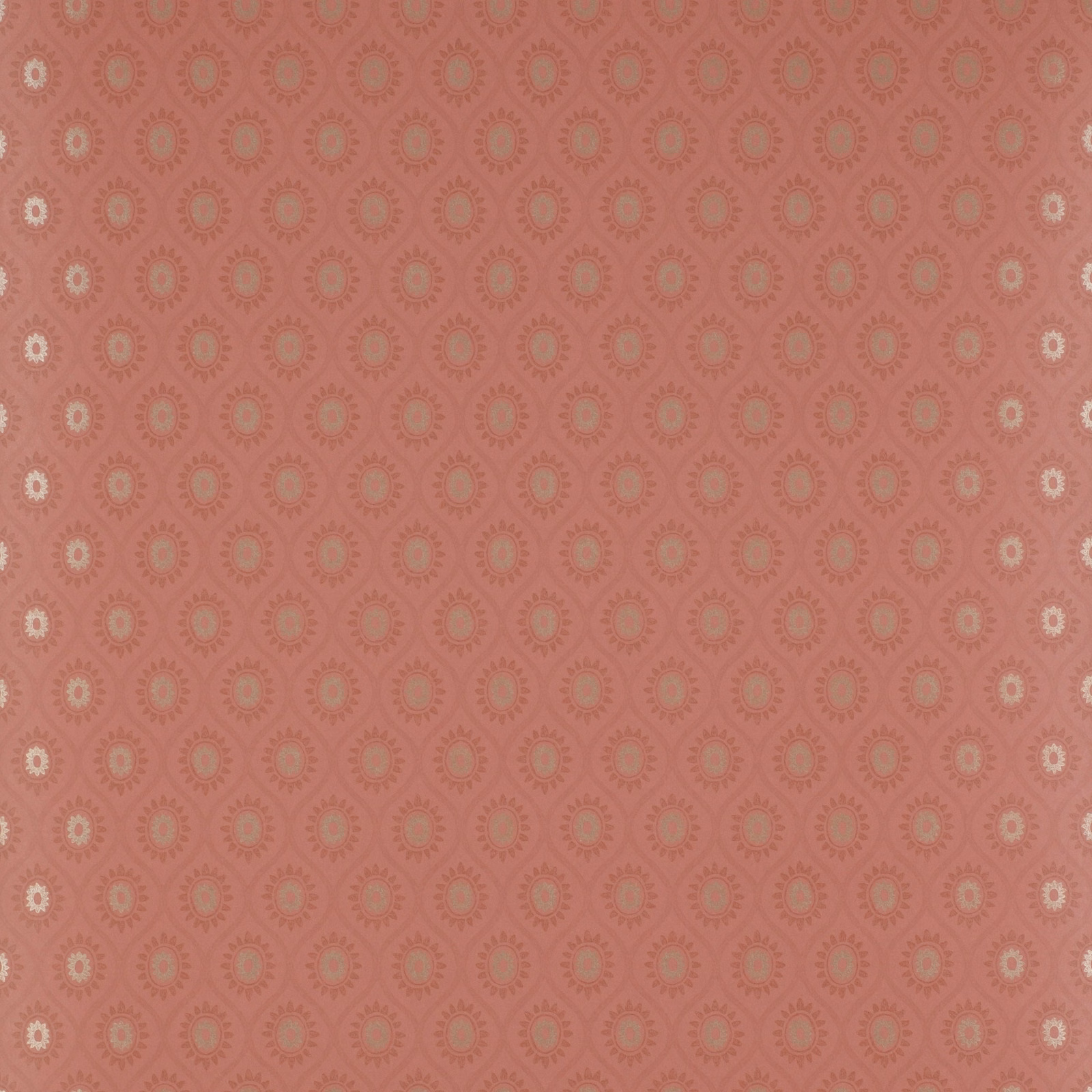 Dusty coral-red wallpaper with small cream and taupe floral medallions