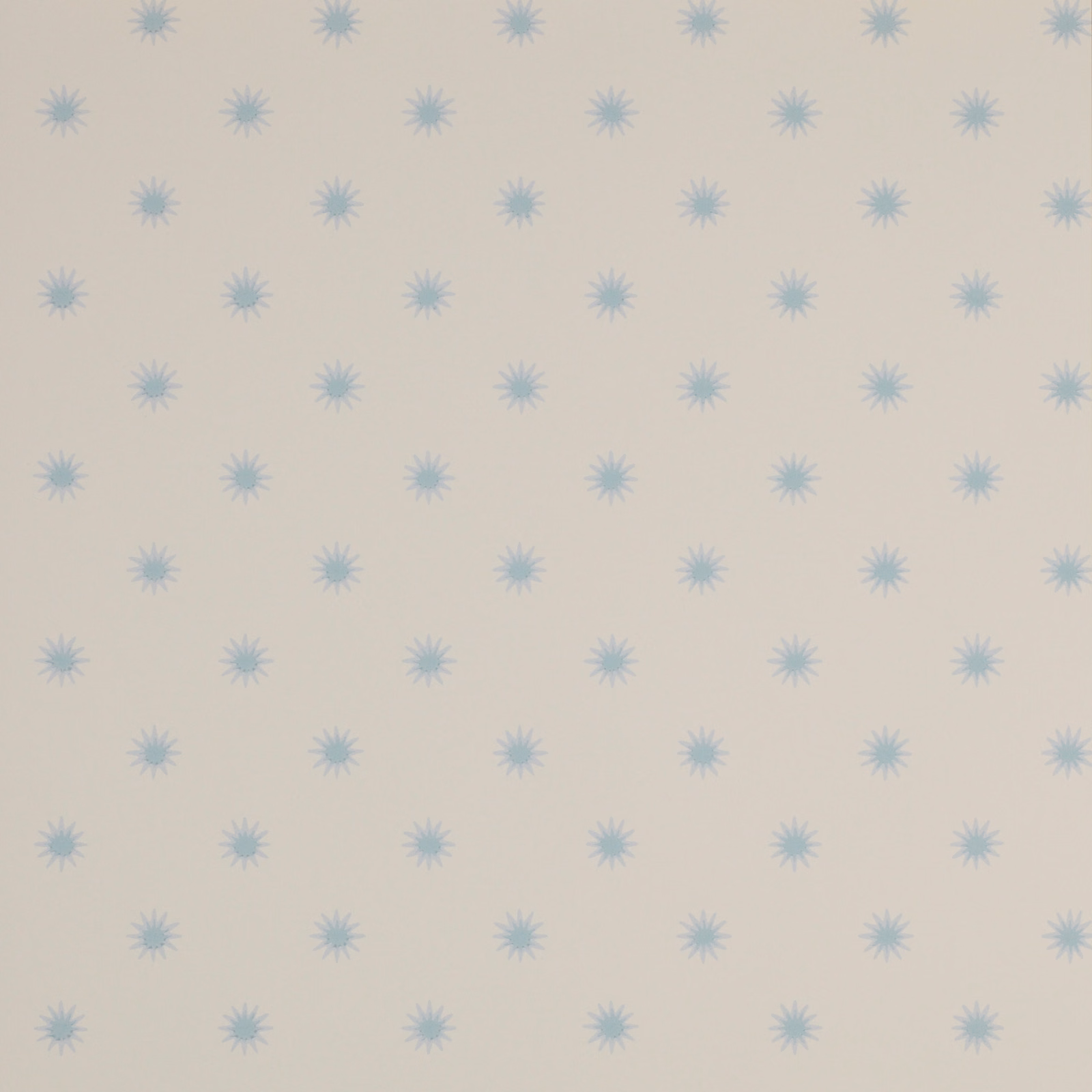 Cream wallpaper with evenly spaced pale powder-blue starburst motifs in a small geometric repeat