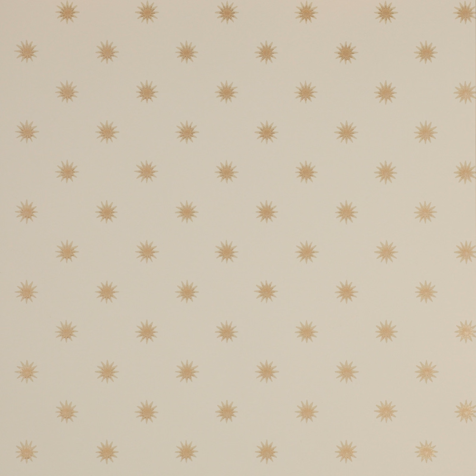 Warm cream wallpaper with evenly spaced muted ochre sunburst motifs