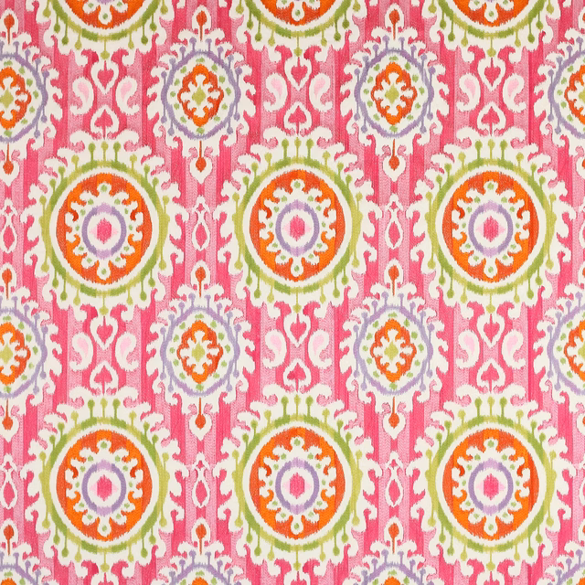 Bright fuchsia patterned fabric with circular medallions in green, orange and lilac