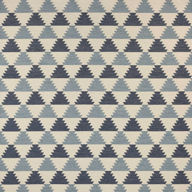 Geometric woven fabric with stepped triangle motifs in pale blue and navy on a light ground