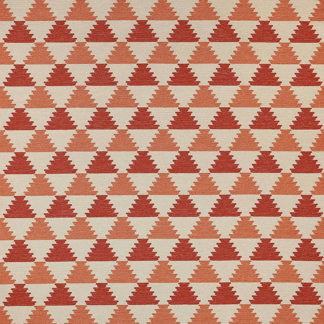 Geometric woven fabric with stepped triangles in red and red-orange on a pale ground