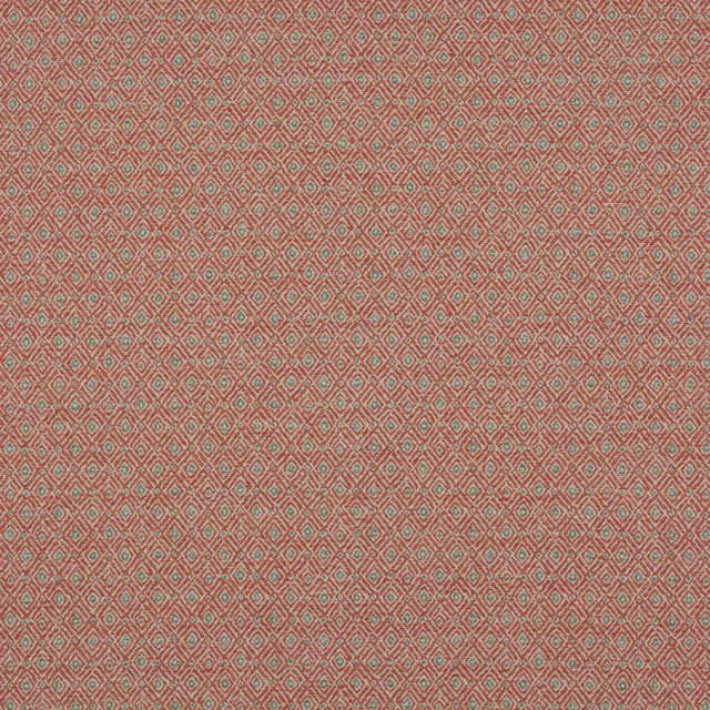 Close-up of small diamond geometric fabric in warm terracotta red with muted green and pale accents