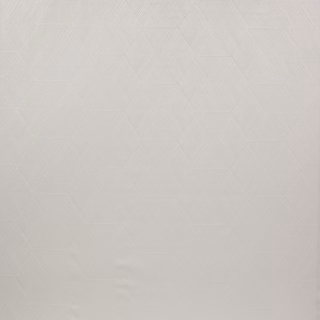 Pale ivory geometric woven fabric with subtle faceted texture