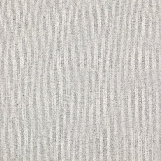 Close-up of pale grey herringbone woven fabric with fine texture