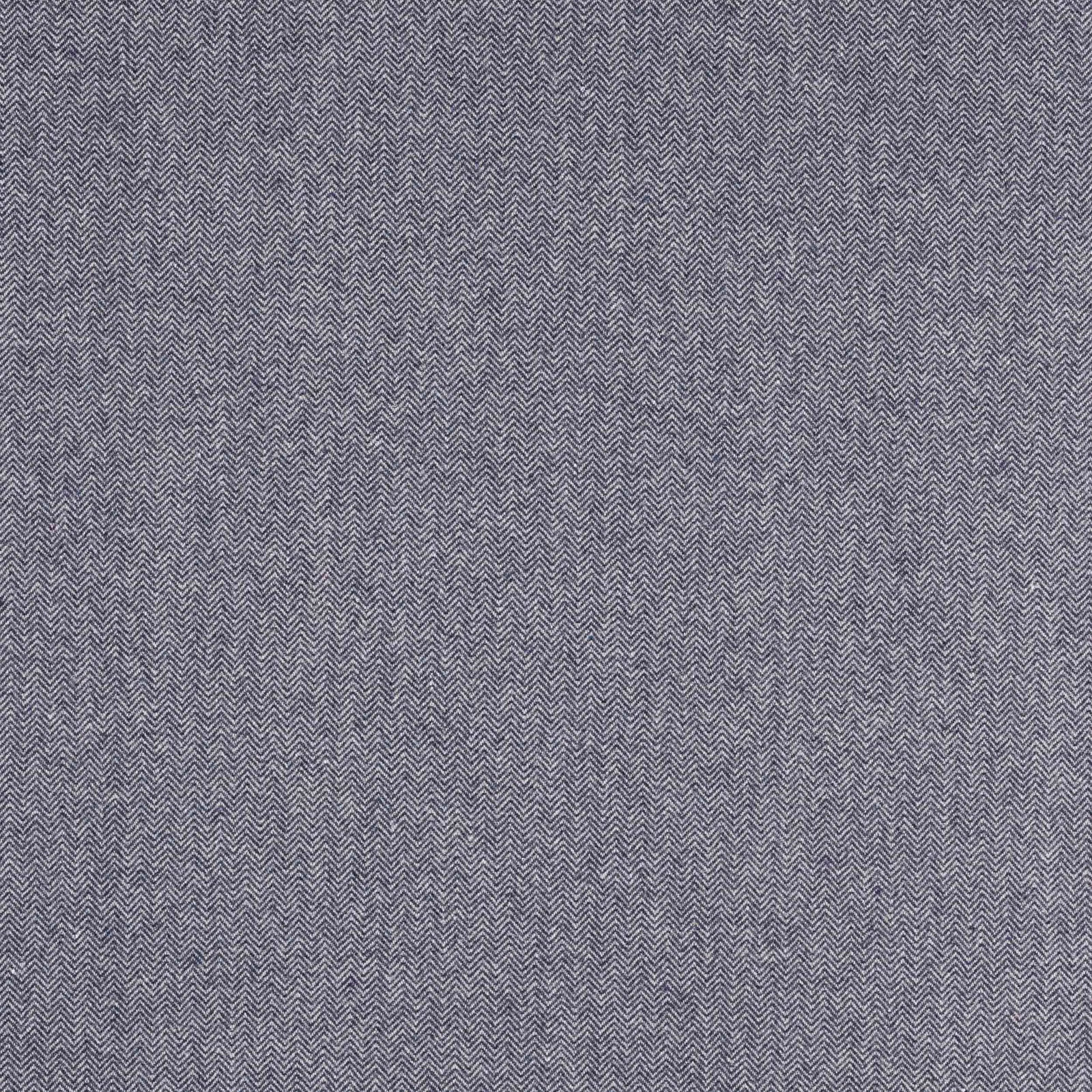 Close-up of muted indigo herringbone woven fabric with fine zigzag texture