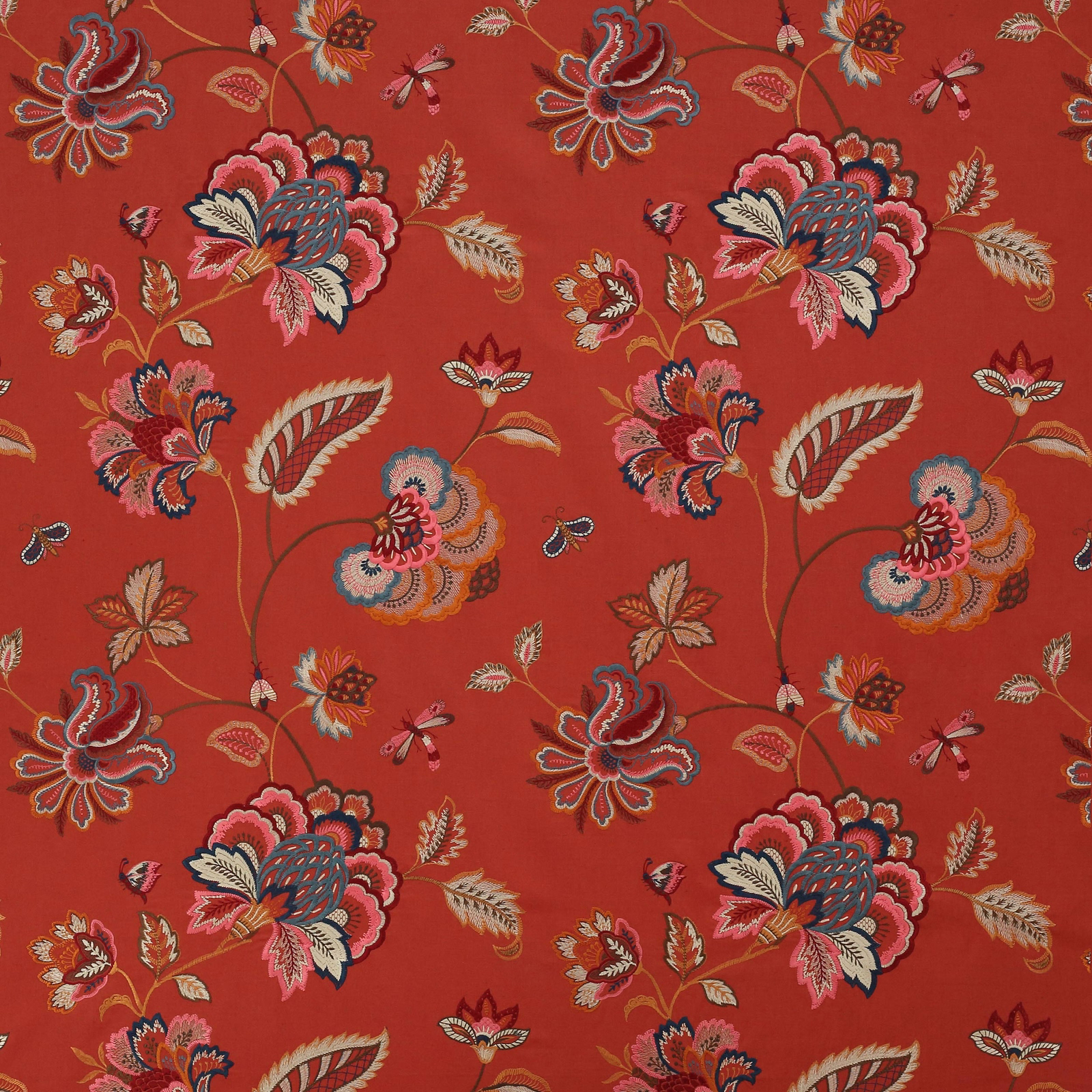 Bold floral fabric on a warm red ground with pink, cream and navy motifs