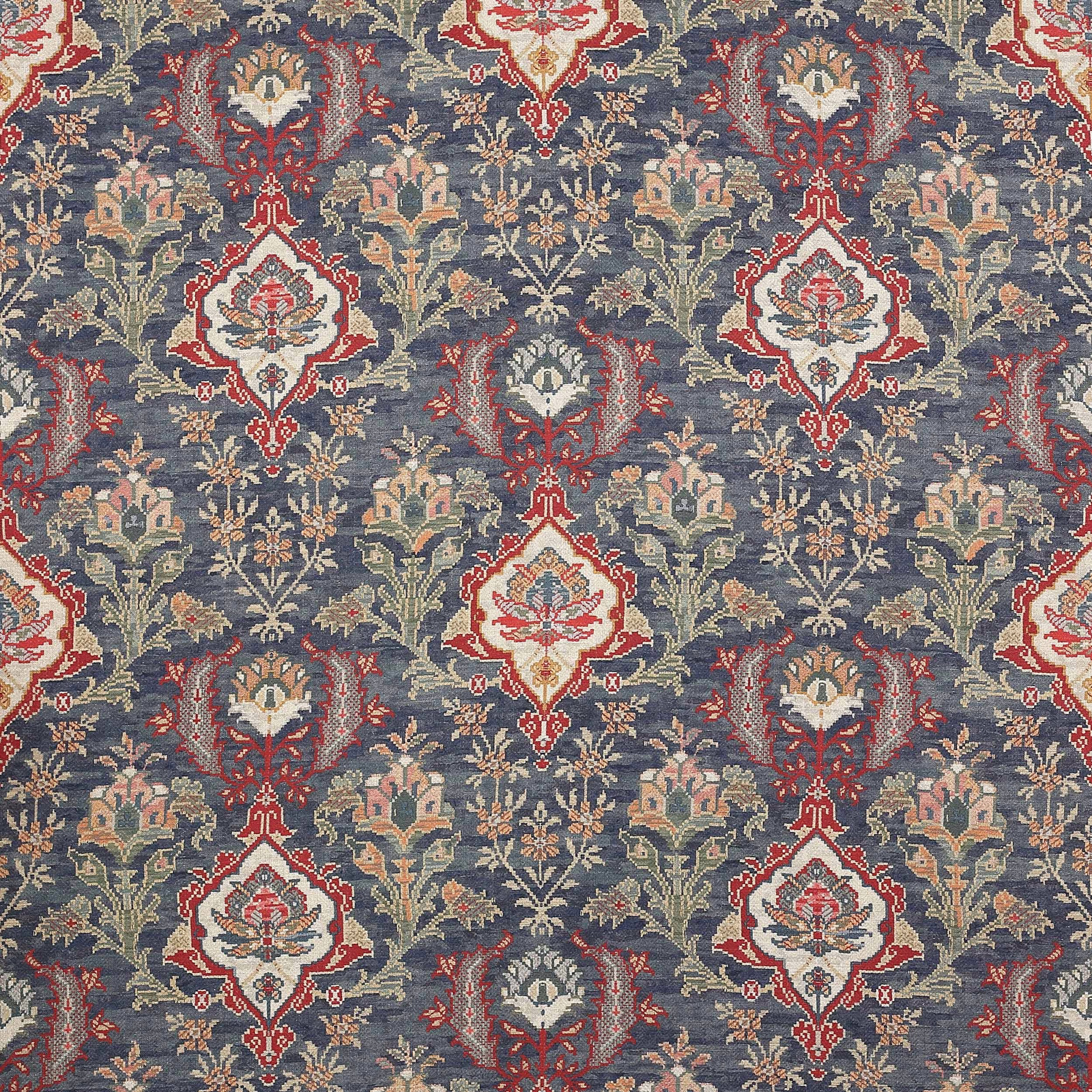 Woven floral fabric swatch in muted navy with cream, red and soft green motifs