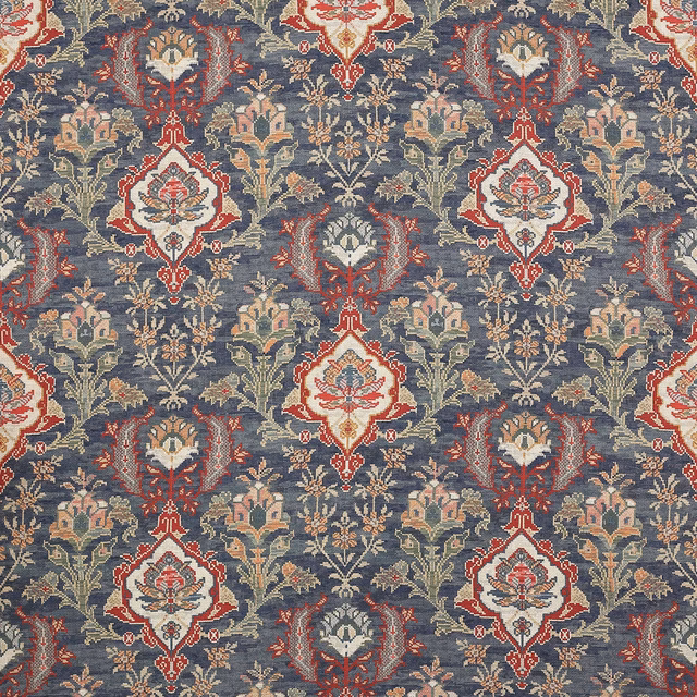 Woven floral fabric swatch in muted navy with cream, red and soft green motifs
