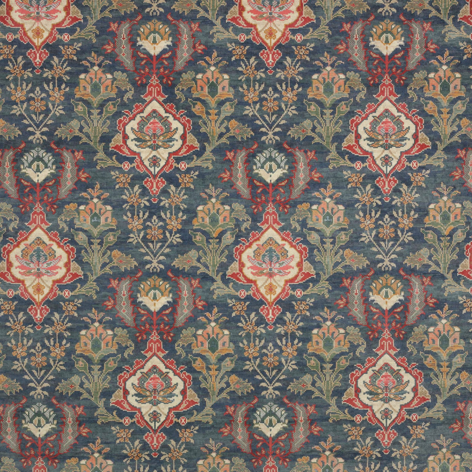 Navy velvet fabric with repeated floral motifs in cream, red, green and gold