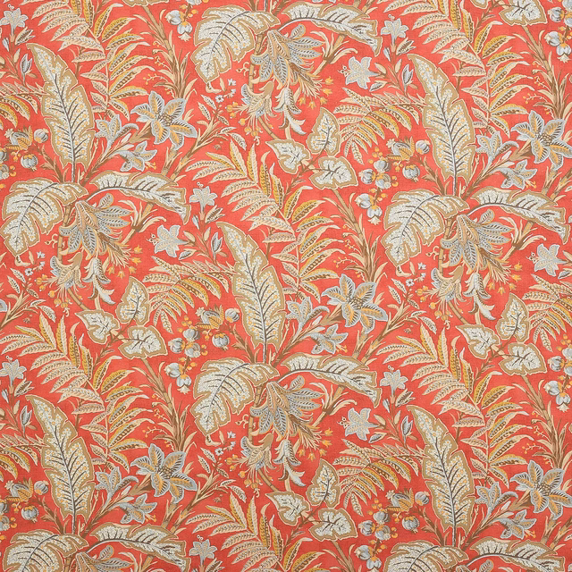 Coral red linen fabric with large cream leaf and paisley motifs and pale blue details