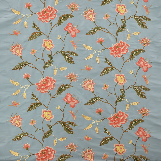 Blue floral fabric with coral blossoms, olive stems and small yellow accents