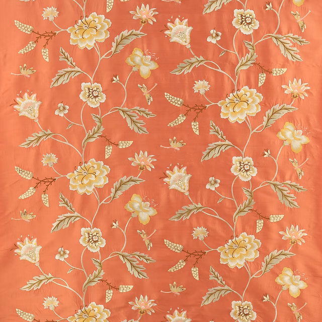 Coral-red floral silk fabric with cream and yellow blossoms and trailing stems