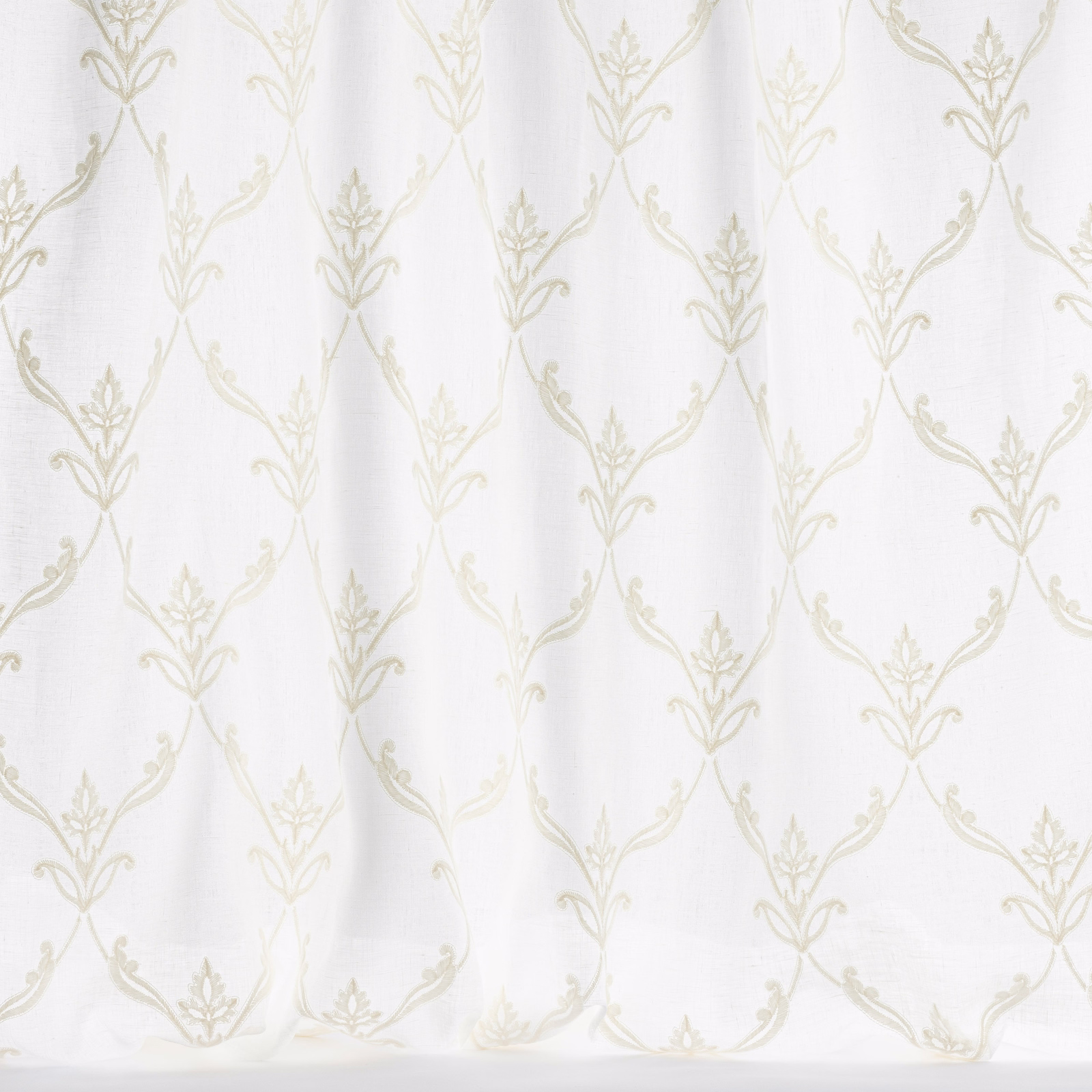 Ivory trellis fabric with pale leaf motif on a white ground