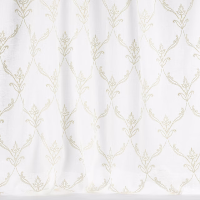 Ivory trellis fabric with pale leaf motif on a white ground