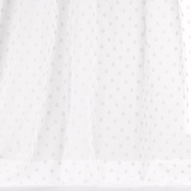 Pale ivory cotton fabric with tiny tonal repeating motif and soft drape