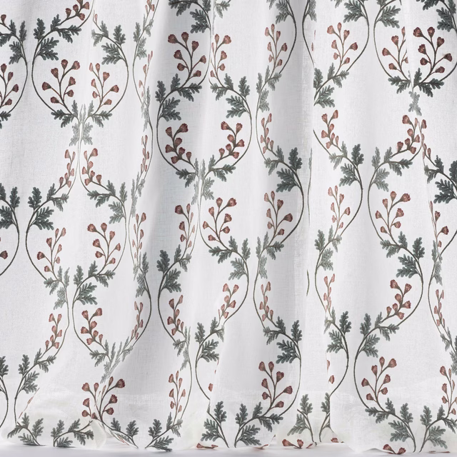 Sheer white fabric with looping vine garlands in muted pink and old blue-green