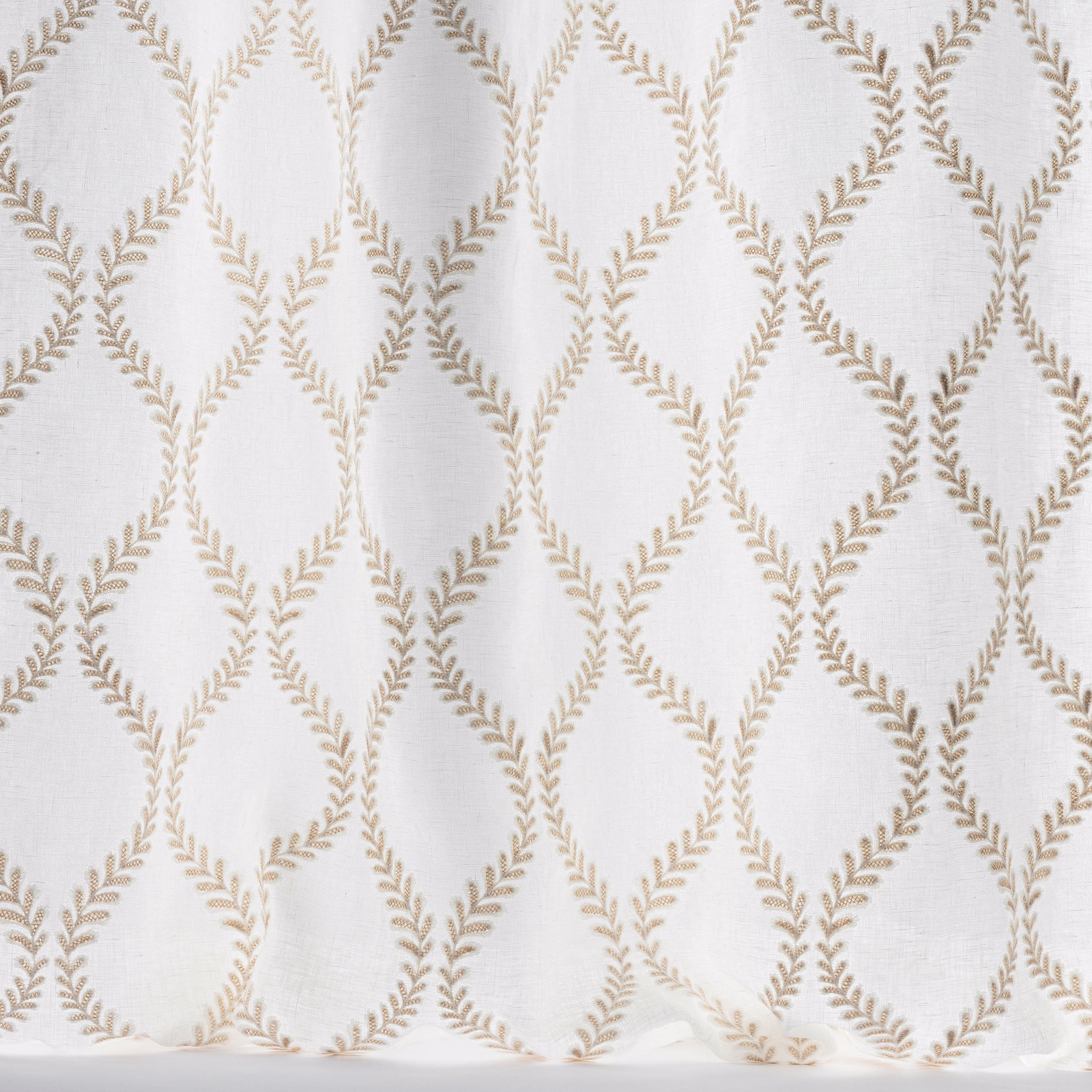 Ivory woven fabric with warm taupe leaf lattice embroidery
