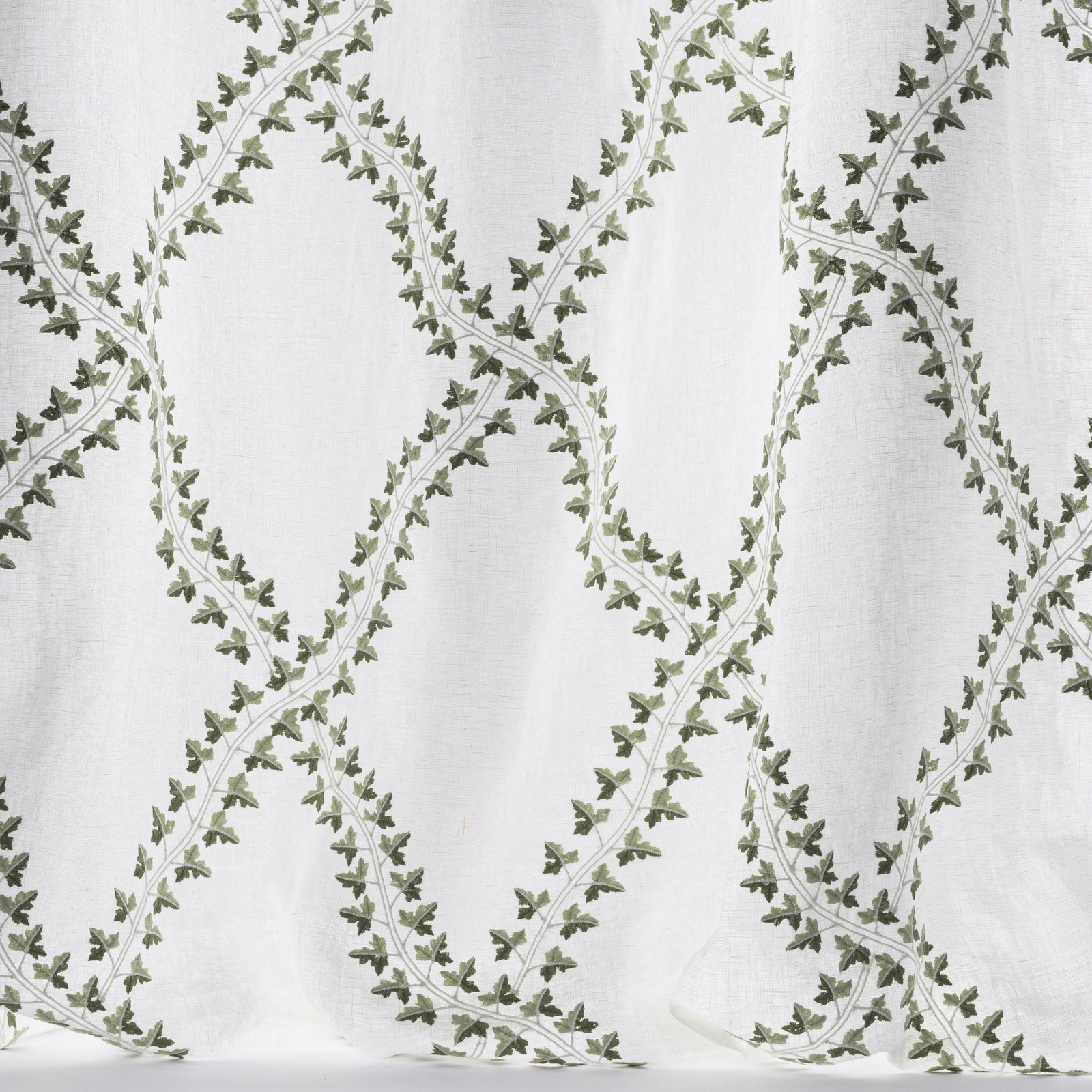 Pale linen-effect fabric with olive green leafy trellis pattern
