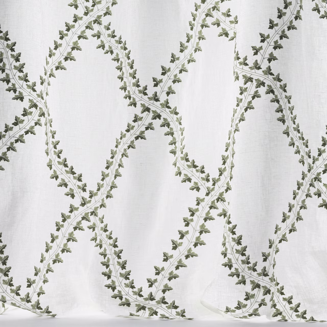 Pale linen-effect fabric with olive green leafy trellis pattern