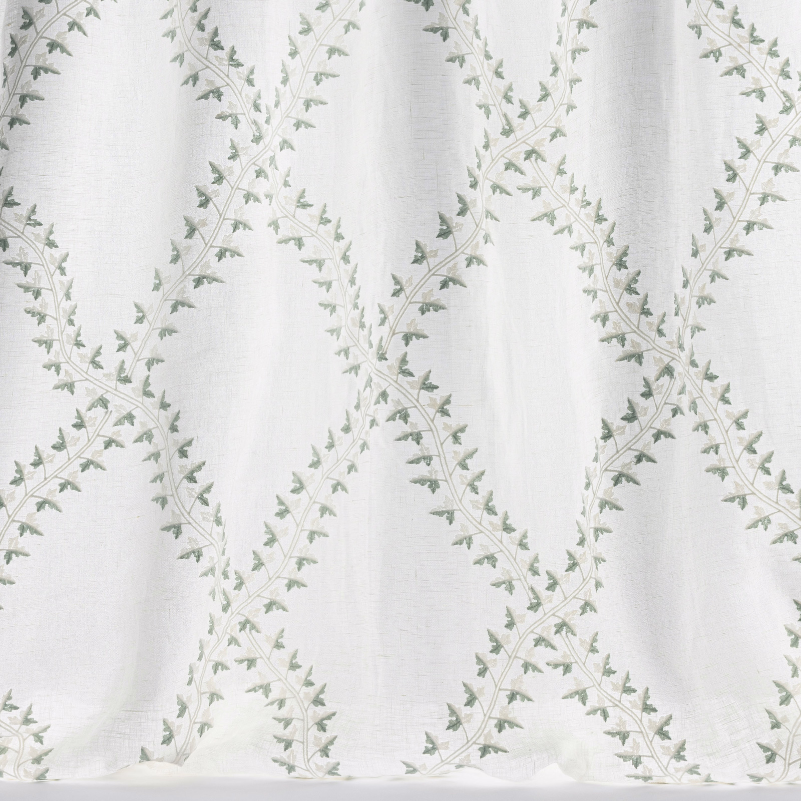 Pale old blue trellis fabric with tiny leaf sprigs on a light ground