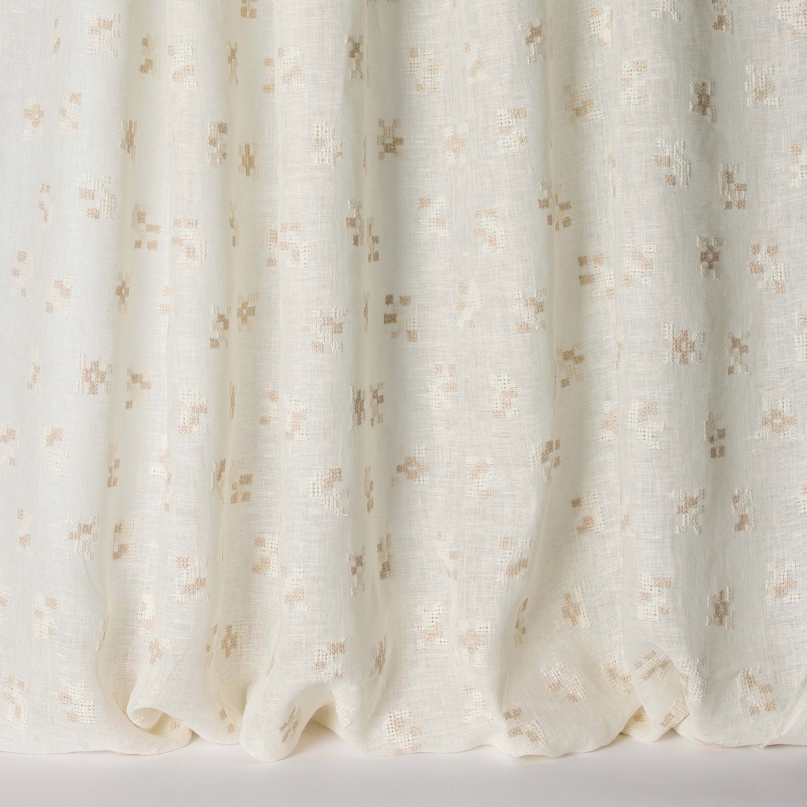 Soft ivory fabric with scattered warm clay flecks and a linen texture