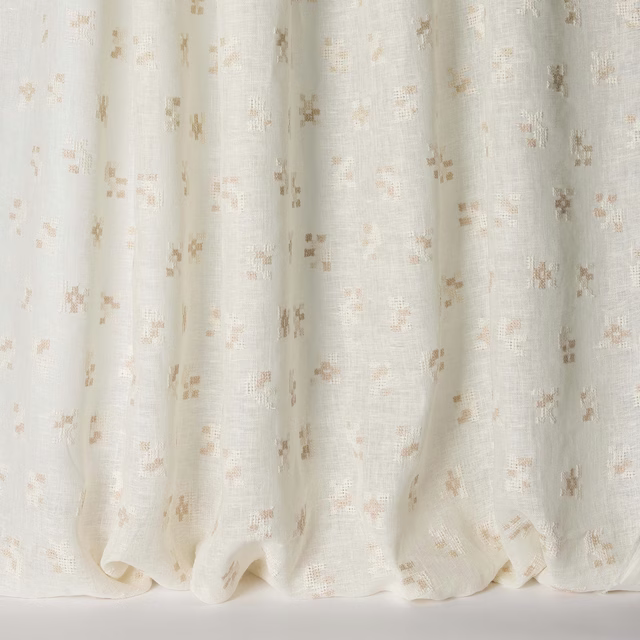 Soft ivory fabric with scattered warm clay flecks and a linen texture
