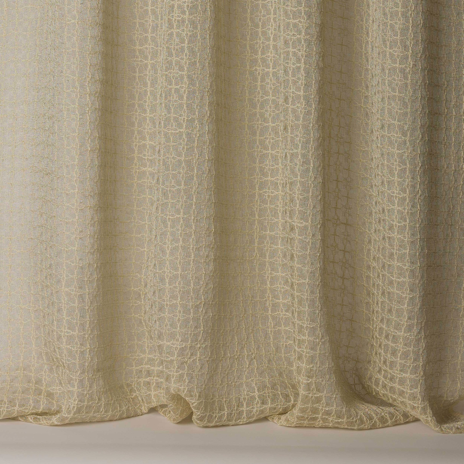 Warm clay-beige textured fabric with a fine cracked grid weave and soft folds