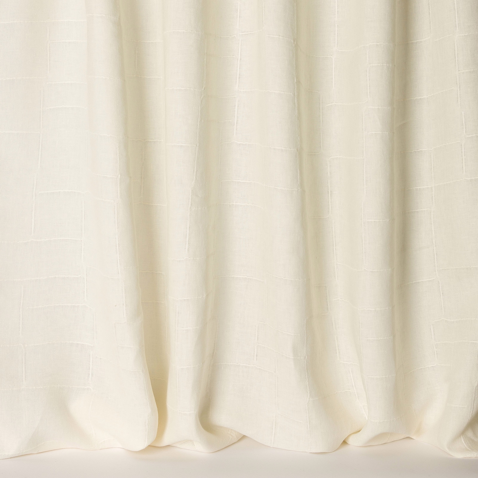 Cream linen curtain fabric with a subtle woven grid and soft hanging folds