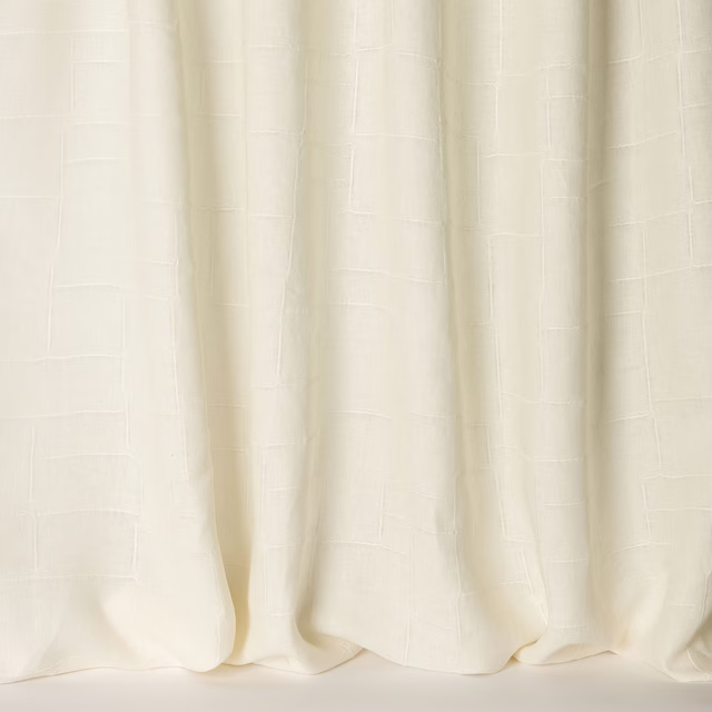 Cream linen curtain fabric with a subtle woven grid and soft hanging folds
