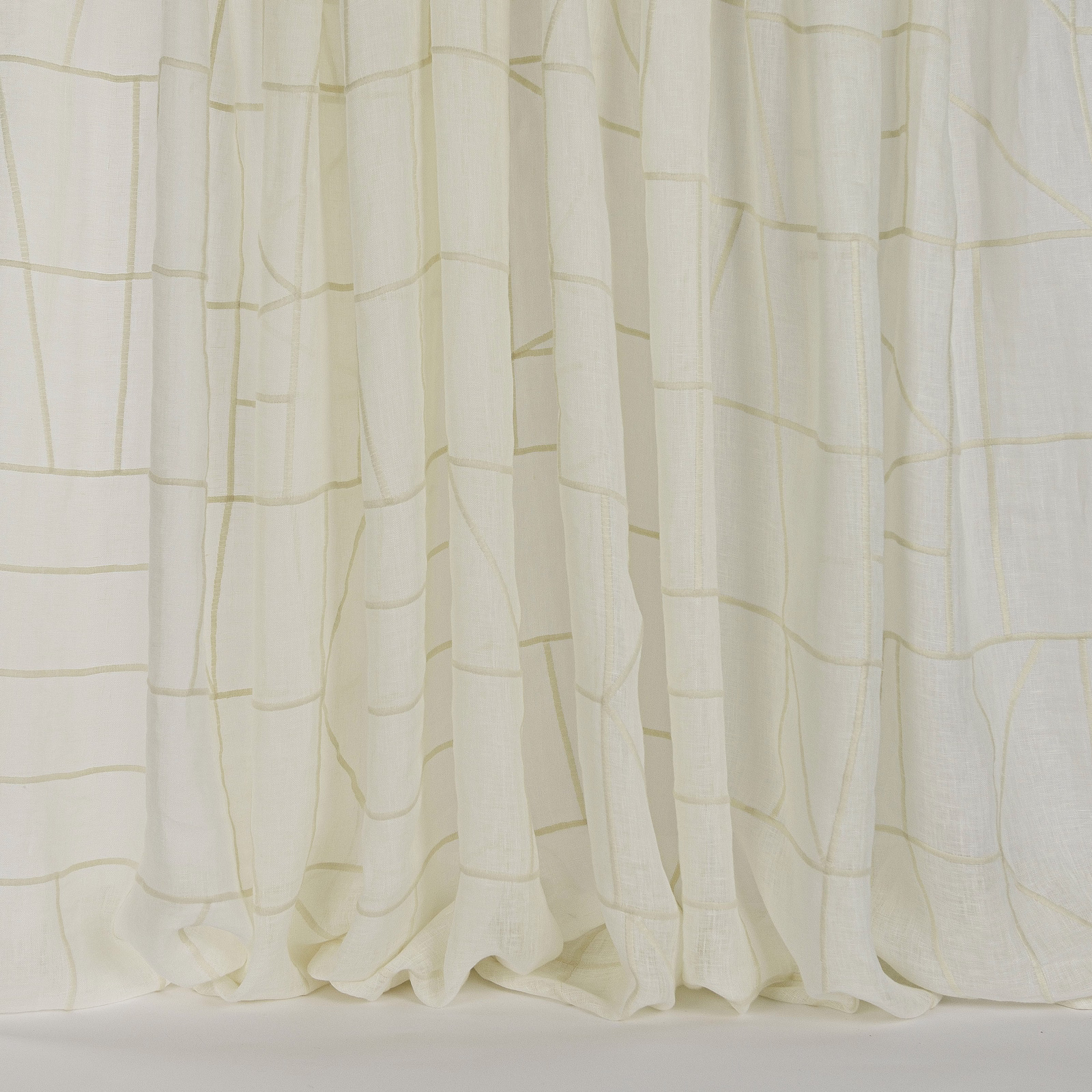 Soft cream curtain fabric with a subtle woven grid and flowing folds