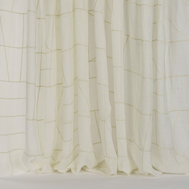 Soft cream curtain fabric with a subtle woven grid and flowing folds