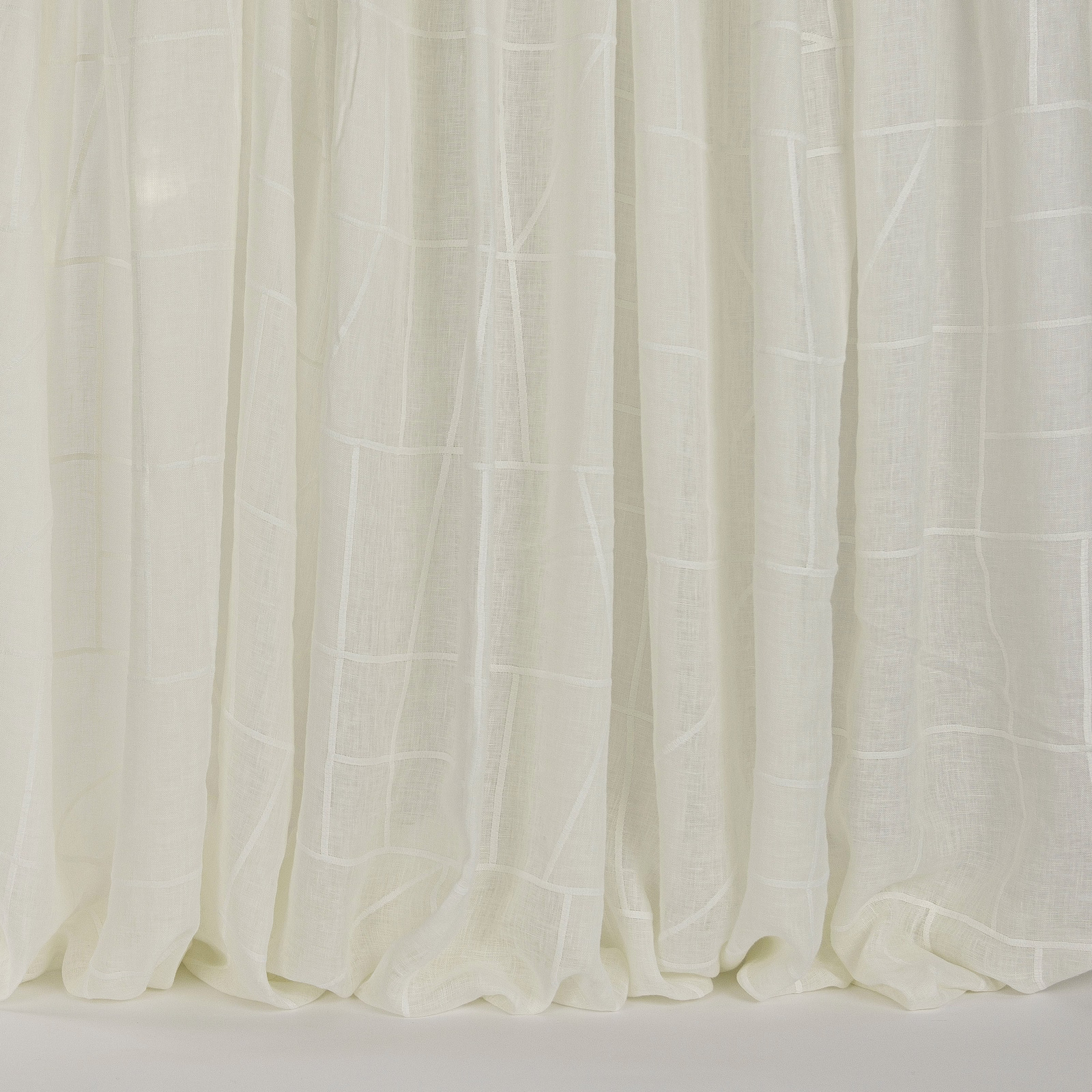 Soft ivory sheer curtains with subtle woven vertical panel pattern