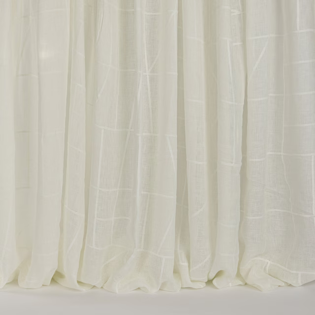 Soft ivory sheer curtains with subtle woven vertical panel pattern