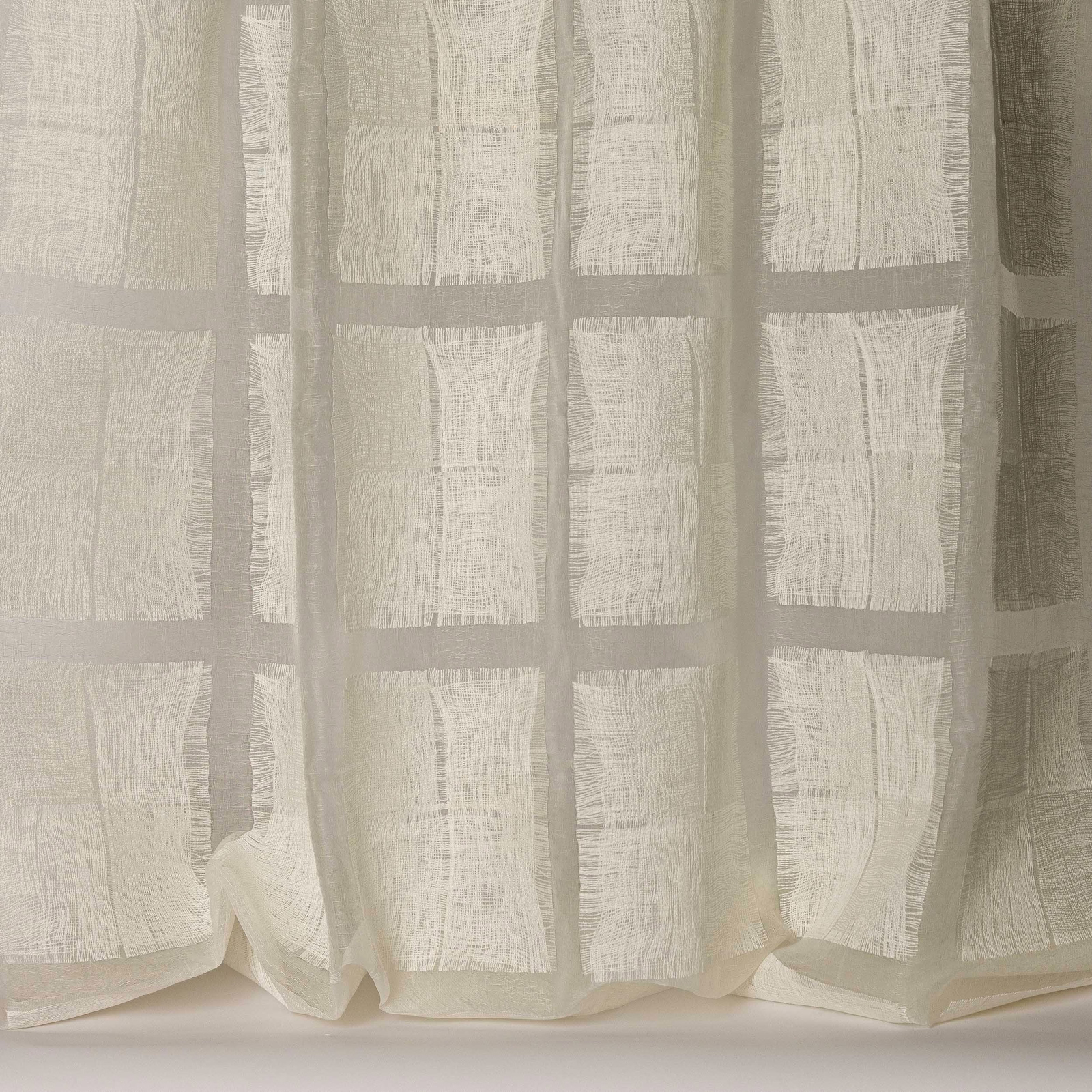 Sheer ivory fabric with a soft square grid and slubby woven texture