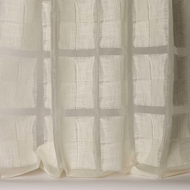 Sheer ivory fabric with a soft square grid and slubby woven texture