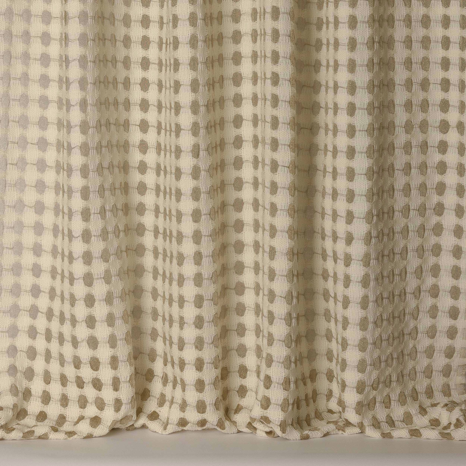 Soft gold-beige woven fabric with small dotted pattern and subtle folds