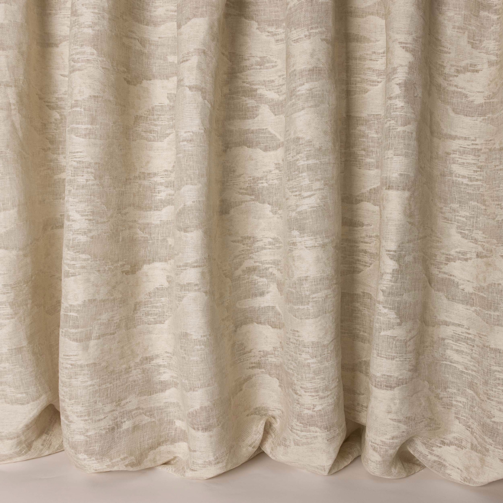 Creamy clay-beige woven fabric with an abstract textured pattern and soft drape