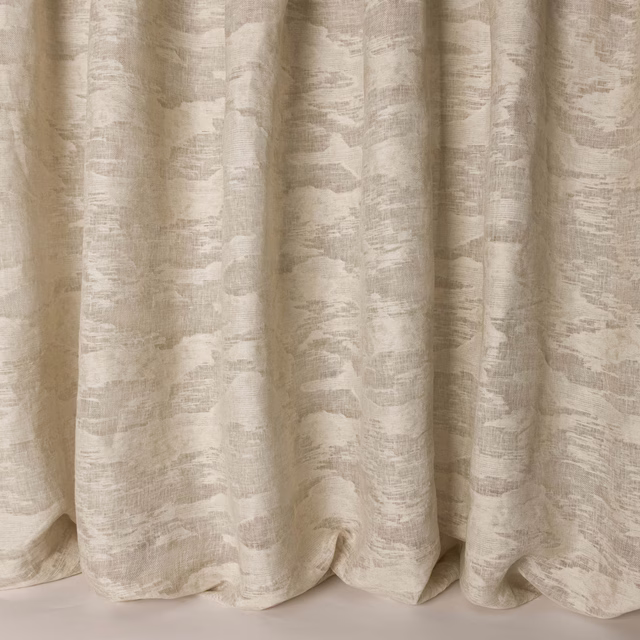 Creamy clay-beige woven fabric with an abstract textured pattern and soft drape